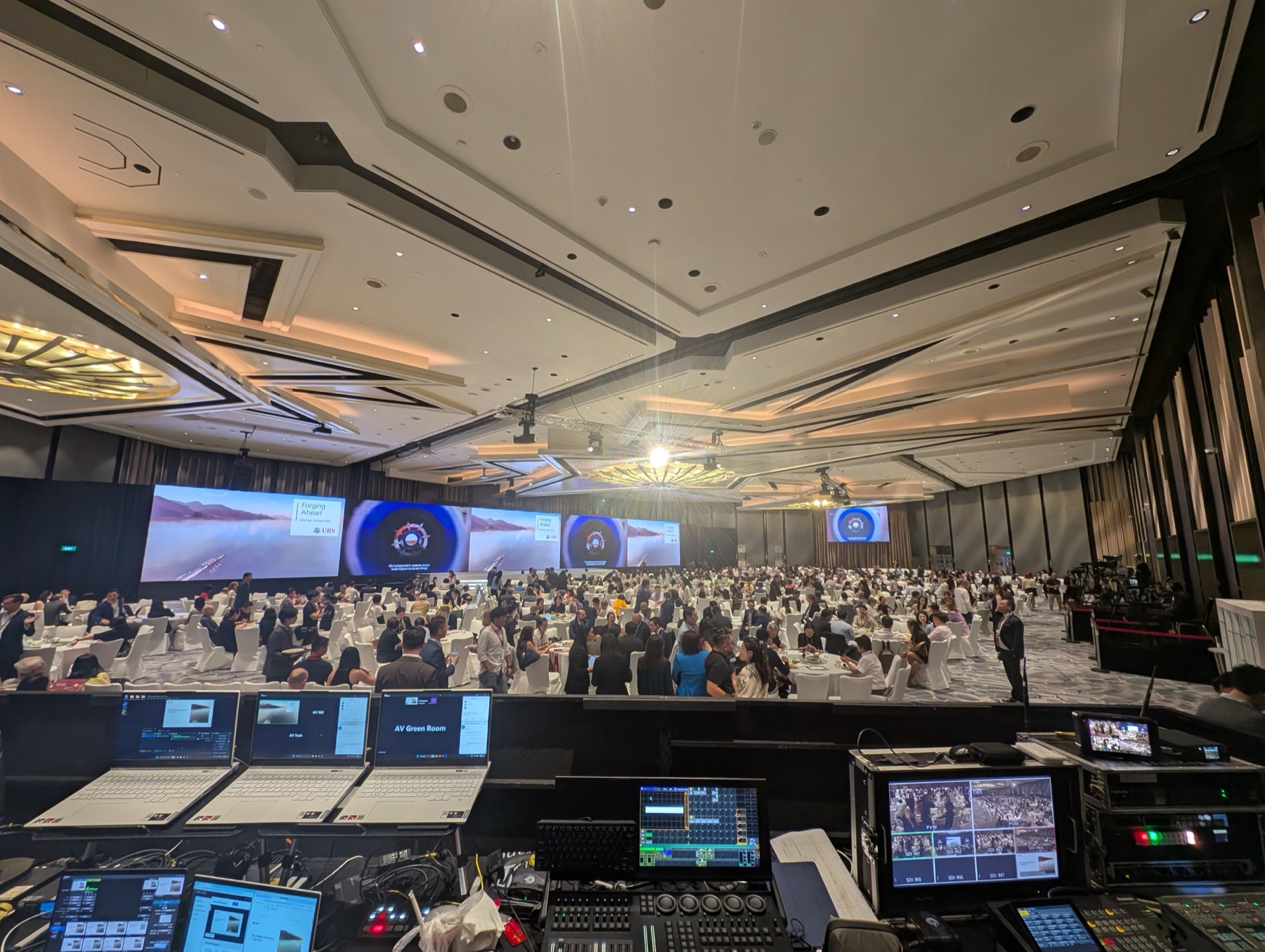 Large-scale conference ballroom with wide LED wall and FOH control