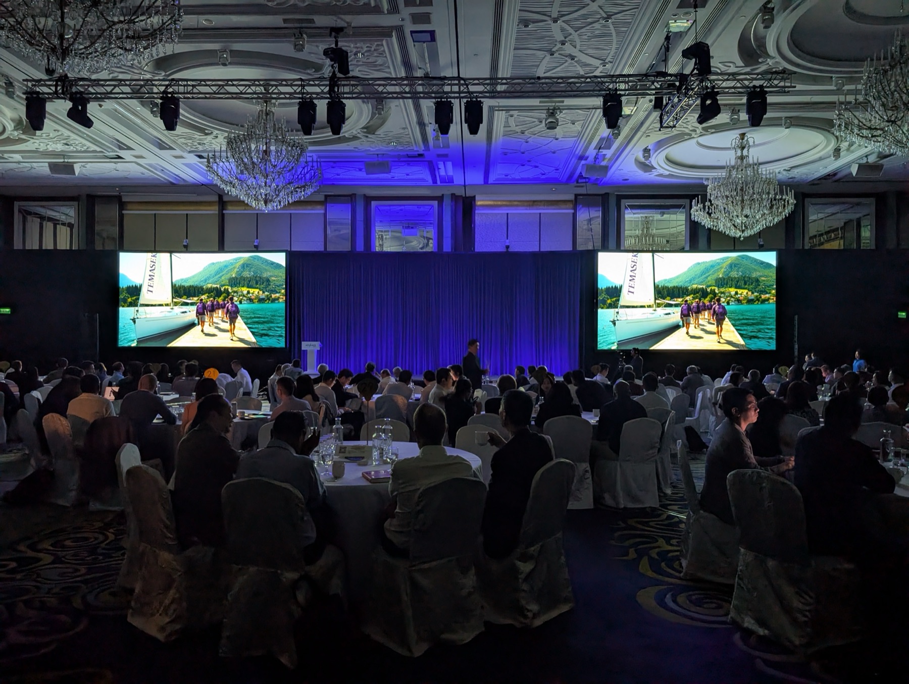 Investor conference FOH desk with multi-screen ballroom setup